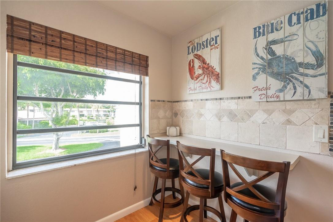 21650 Juego Circle, Unit 24F Boca Raton, FL 33433 - Photo 6 of 24 a view of a dining room with furniture window and outside view