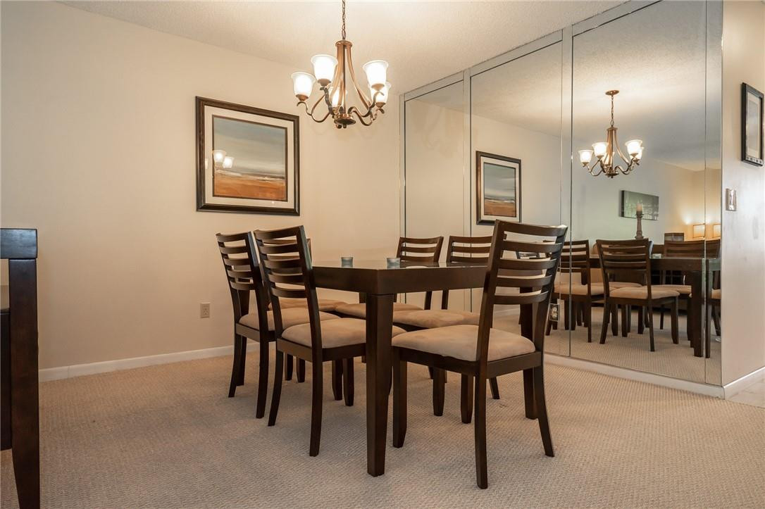 21650 Juego Circle, Unit 24F Boca Raton, FL 33433 - Photo 8 of 24 a view of a dining room with furniture and chandelier