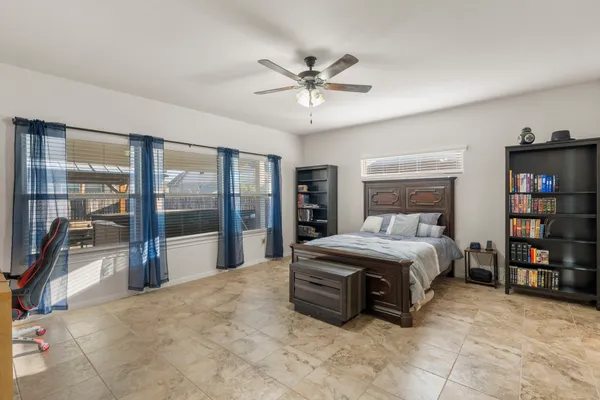 a spacious bedroom with a bed and a large window