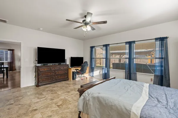 a bedroom with a bed and a flat screen tv