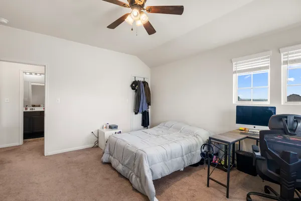 a bedroom with a bed and a window