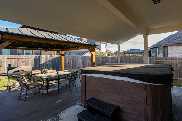a backyard of a house with table and chairs