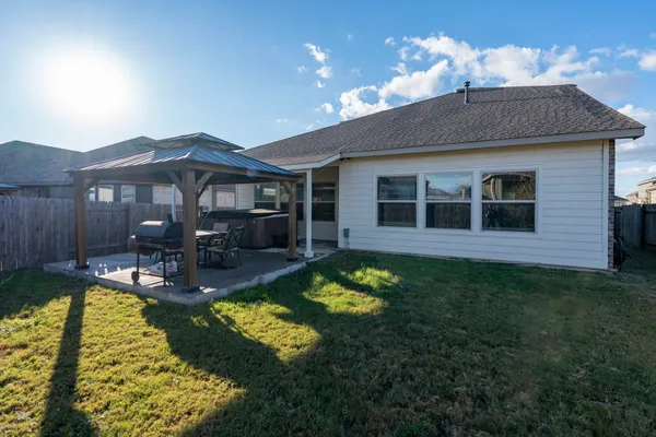 a view of a house with swimming pool and porch with furniture