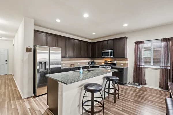 a kitchen with counter top space cabinets and stainless steel appliances
