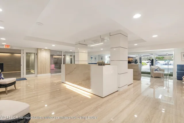 a large white kitchen with lots of counter space and furniture