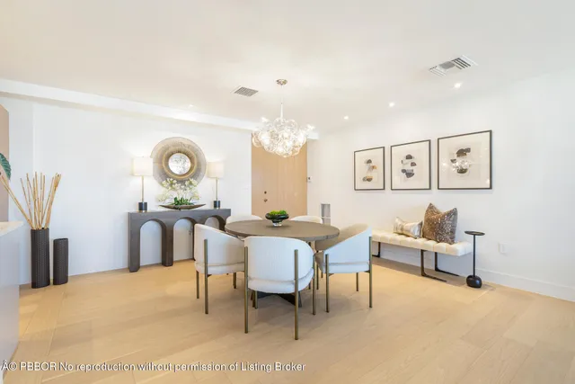 a living room with furniture and a large mirror with wooden floor