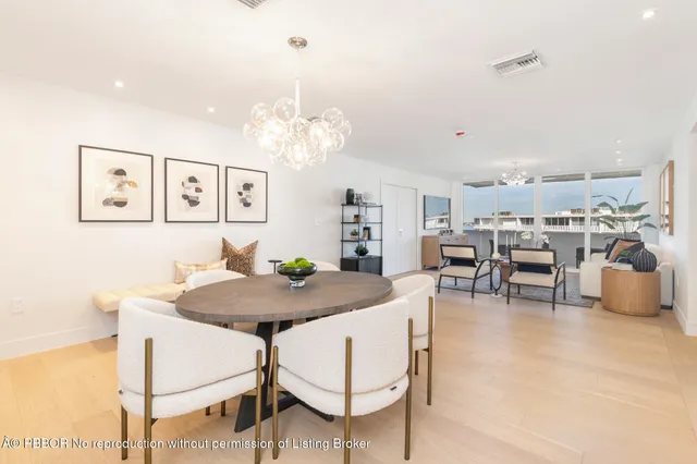 a view of a dining room with furniture and a chandelier