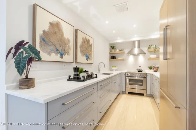 a kitchen with stainless steel appliances a sink and cabinets