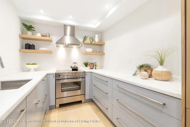 a kitchen with kitchen island white cabinets and white appliances