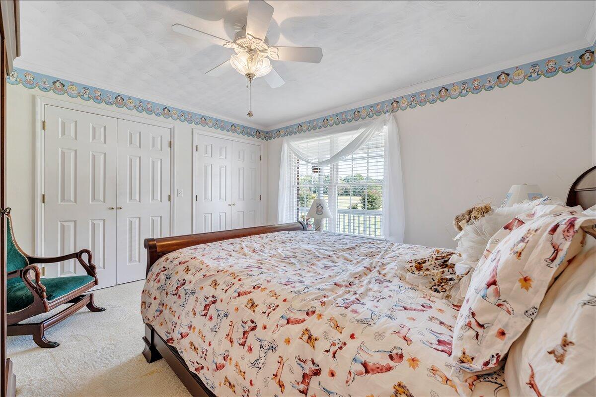 3991 Green Level Road Rocky Mount, VA 24151 - Photo 15 of 49 a bedroom with a bed and a chandelier