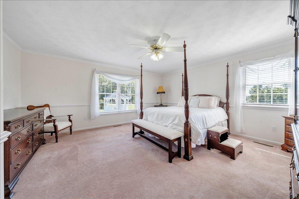 3991 Green Level Road Rocky Mount, VA 24151 - Photo 17 of 49 a spacious bedroom with a bed a desk and chair