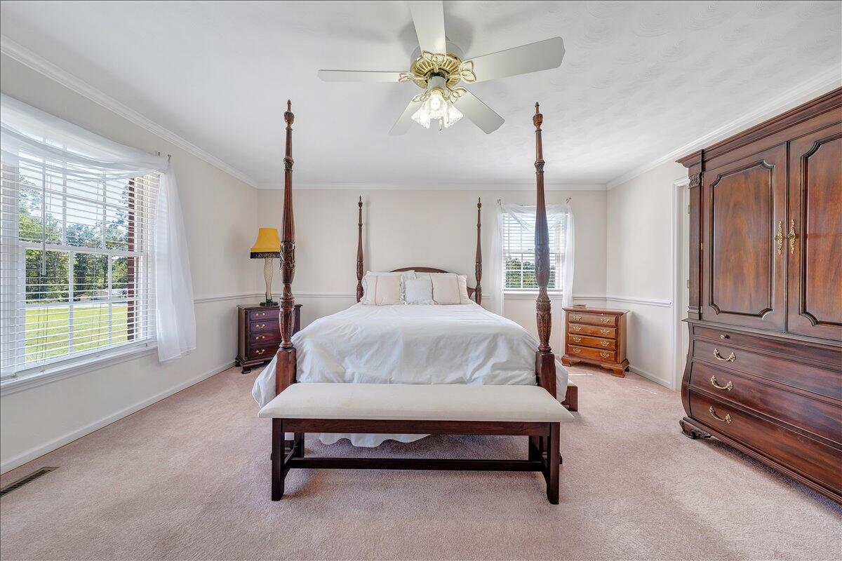3991 Green Level Road Rocky Mount, VA 24151 - Photo 18 of 49 a spacious bedroom with a bed chandelier and window