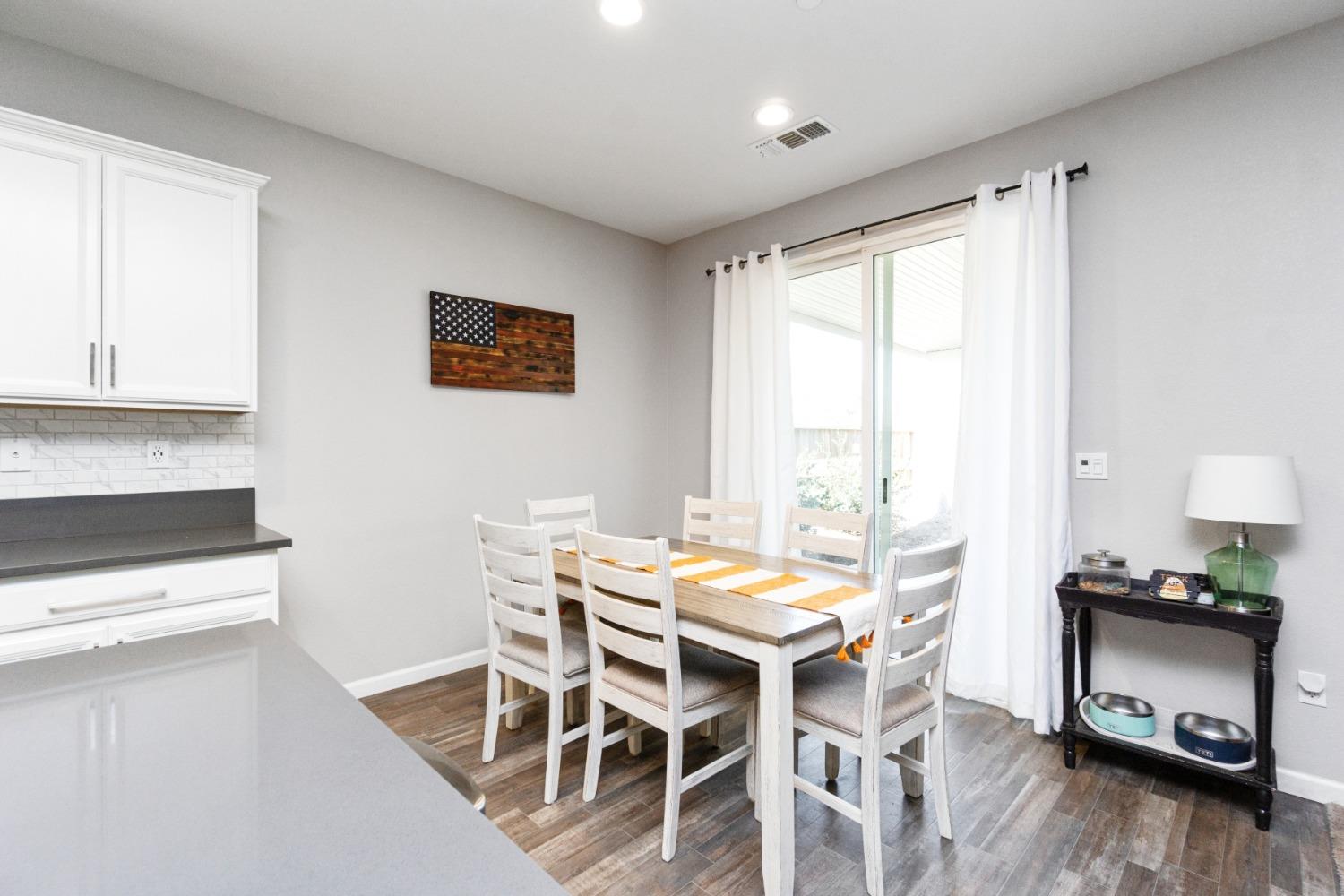 14340 West David Avenue Kerman, CA 93630 - Photo 13 of 30 a view of a dining room with furniture and wooden floor