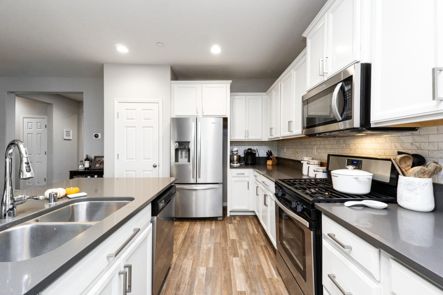 14340 West David Avenue Kerman, CA 93630 - Photo 15 of 30 a kitchen with kitchen island granite countertop a sink stainless steel appliances and cabinets
