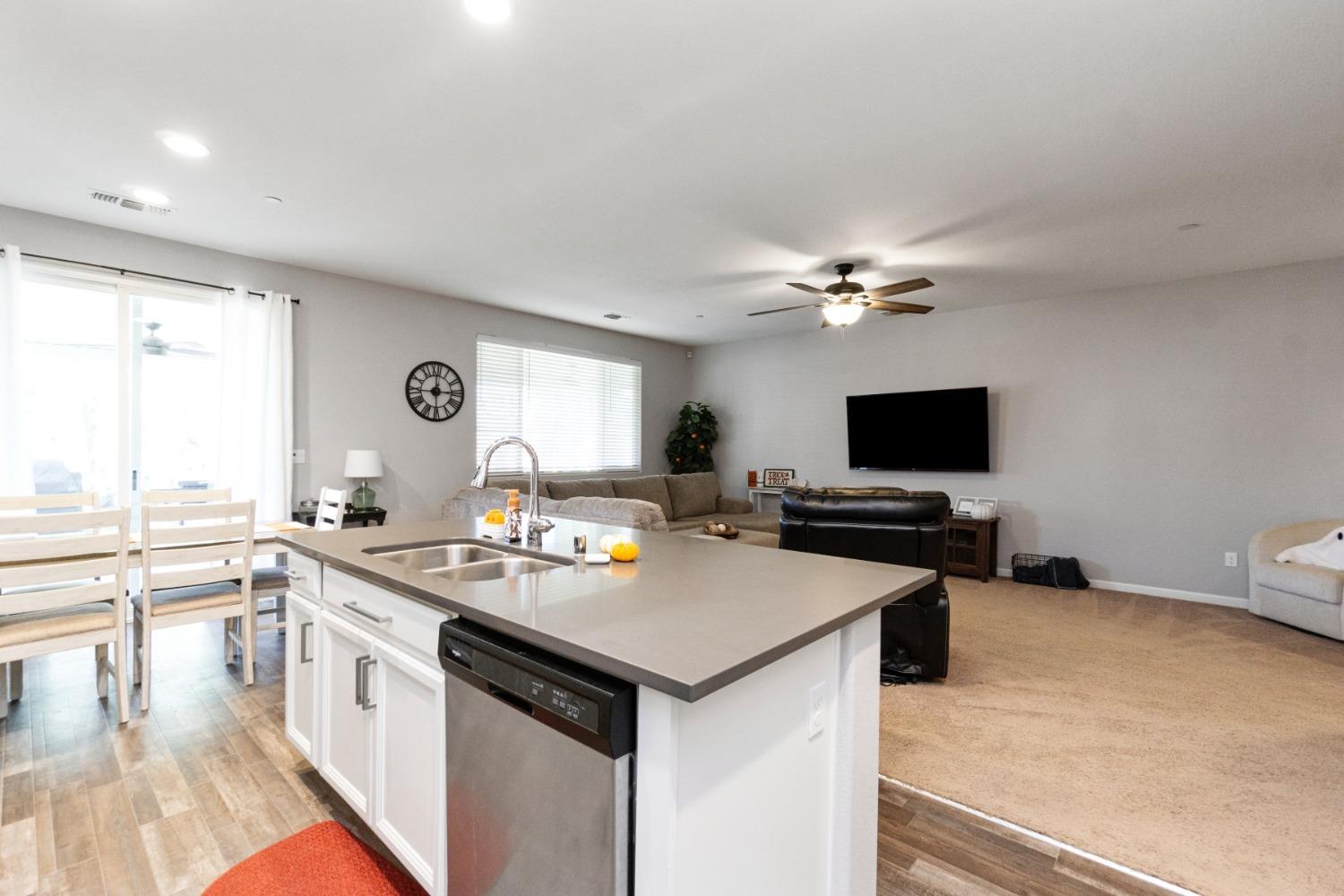 14340 West David Avenue Kerman, CA 93630 - Photo 17 of 30 a kitchen with a stove a sink and a microwave