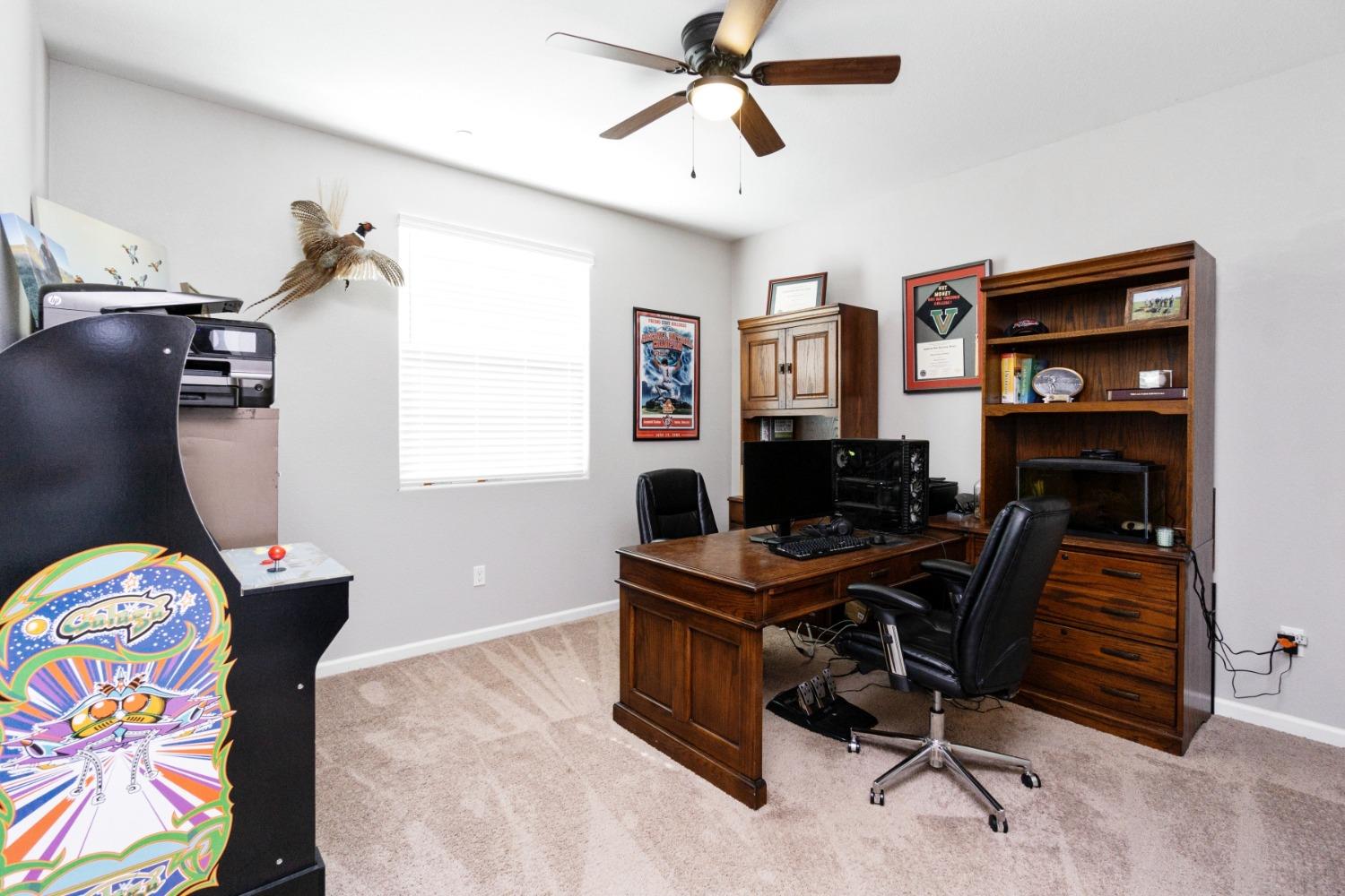 14340 West David Avenue Kerman, CA 93630 - Photo 18 of 30 a view of a workspace with furniture and a window