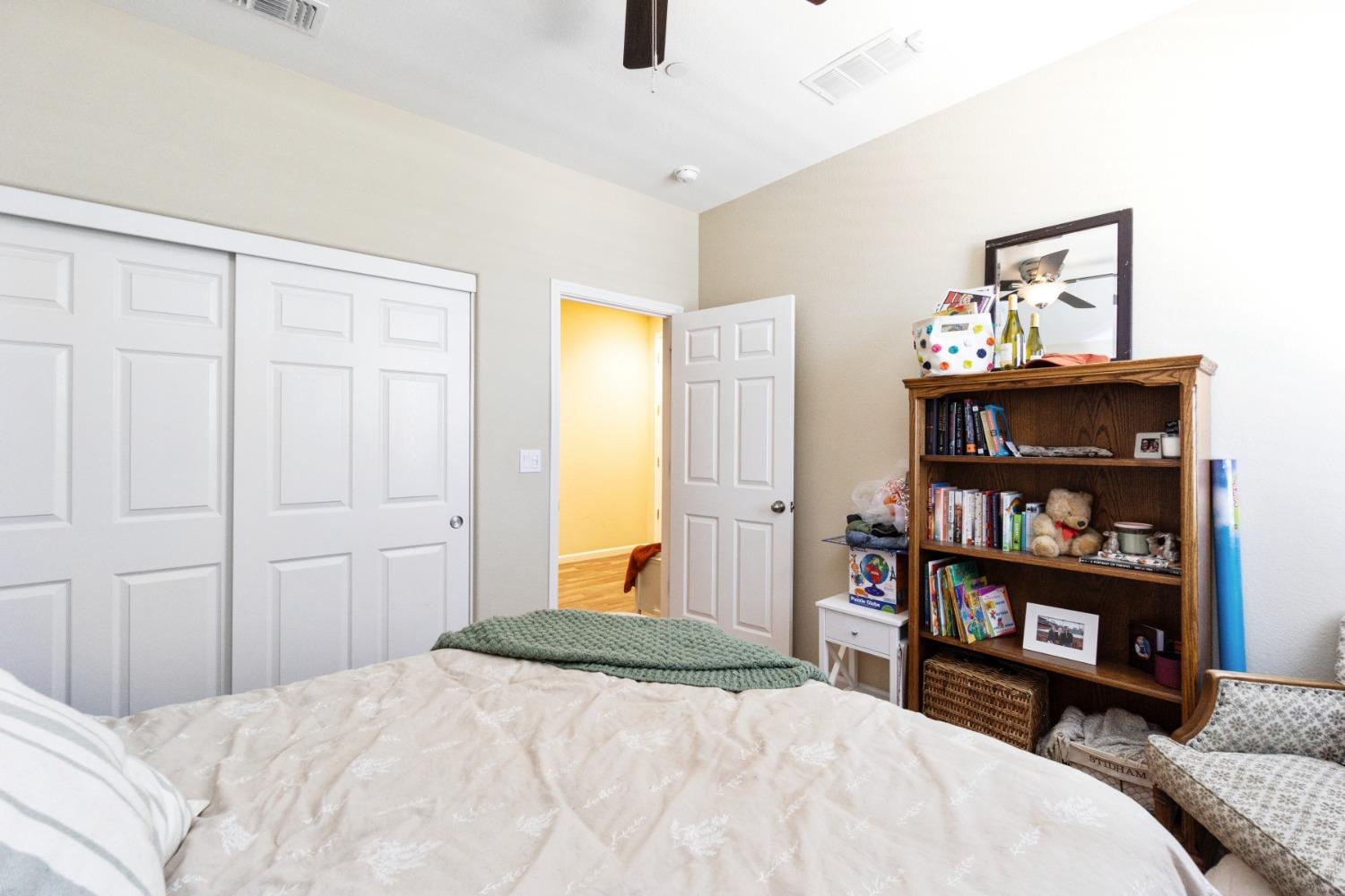 14340 West David Avenue Kerman, CA 93630 - Photo 21 of 30 a bedroom with a bed and a book shelf