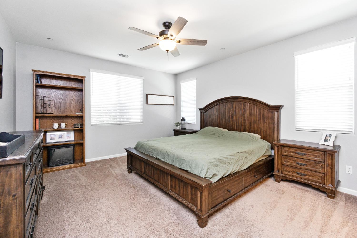 14340 West David Avenue Kerman, CA 93630 - Photo 24 of 30 a bedroom with a bed and dresser with wooden floor