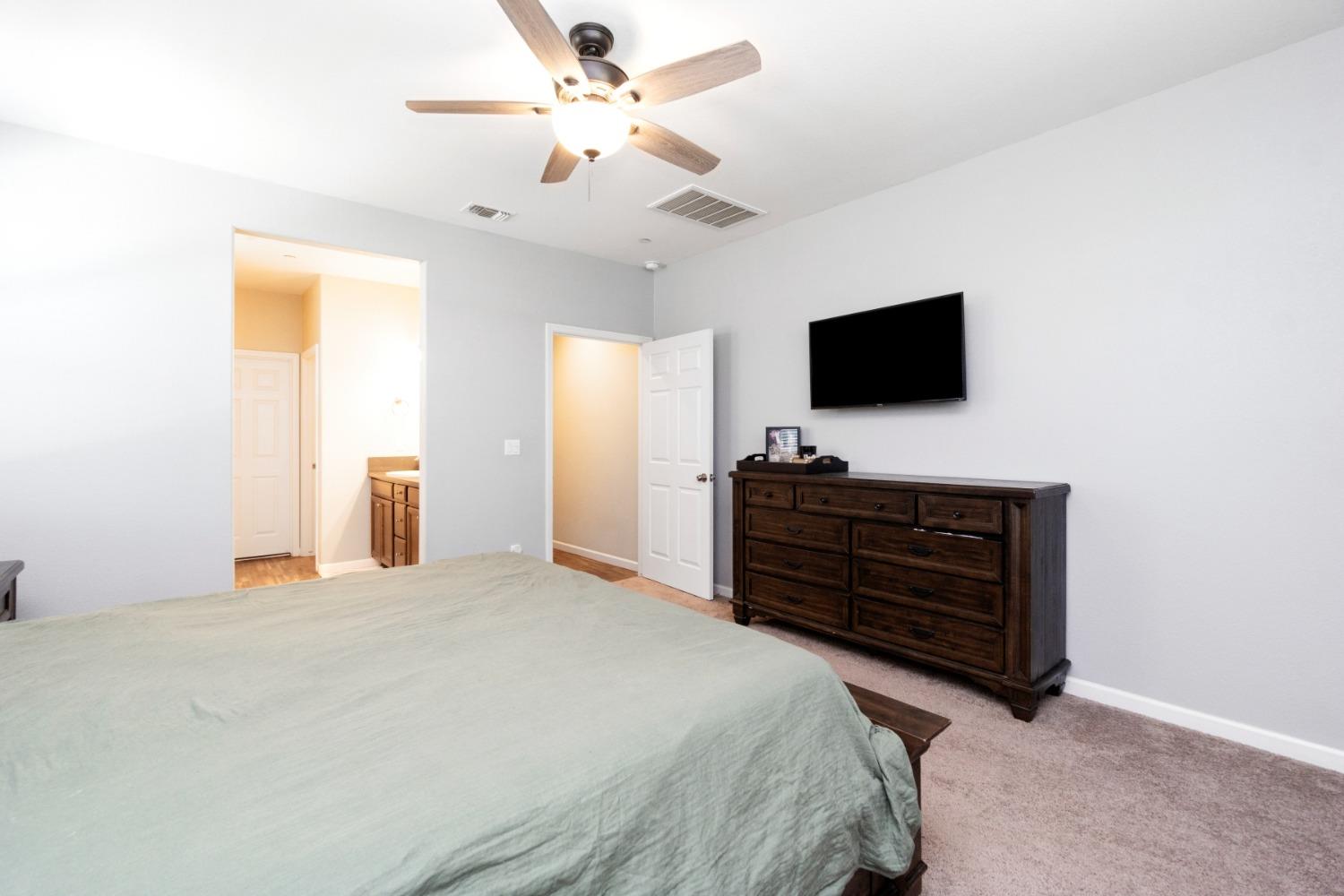 14340 West David Avenue Kerman, CA 93630 - Photo 25 of 30 a bedroom with a bed and a flat screen tv