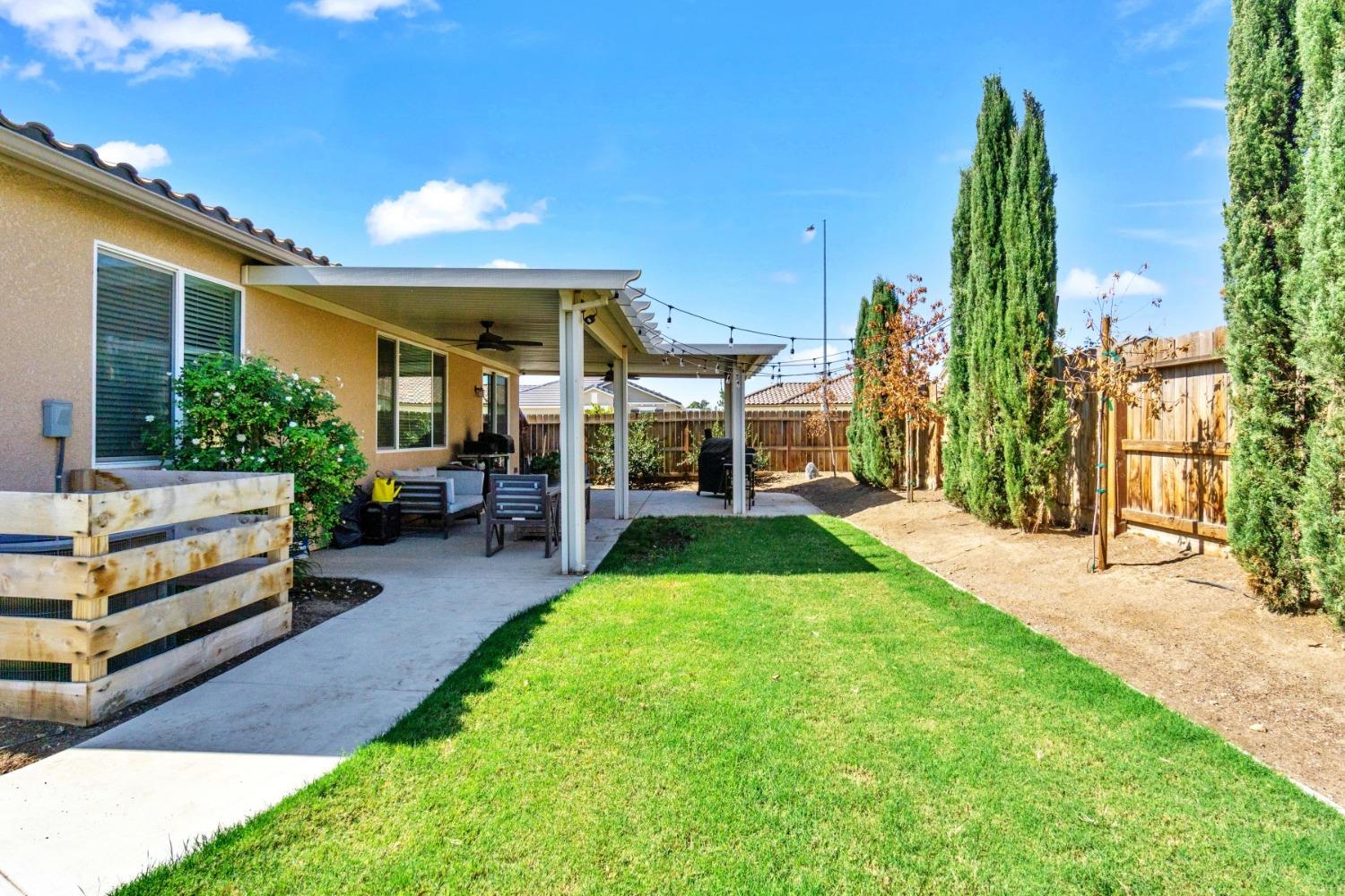 14340 West David Avenue Kerman, CA 93630 - Photo 29 of 30 a front view of a house with a yard