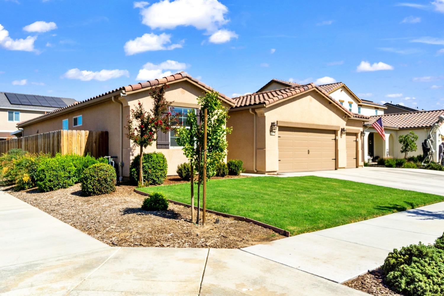 14340 West David Avenue Kerman, CA 93630 - Photo 6 of 30 a view of a house with a yard and plants