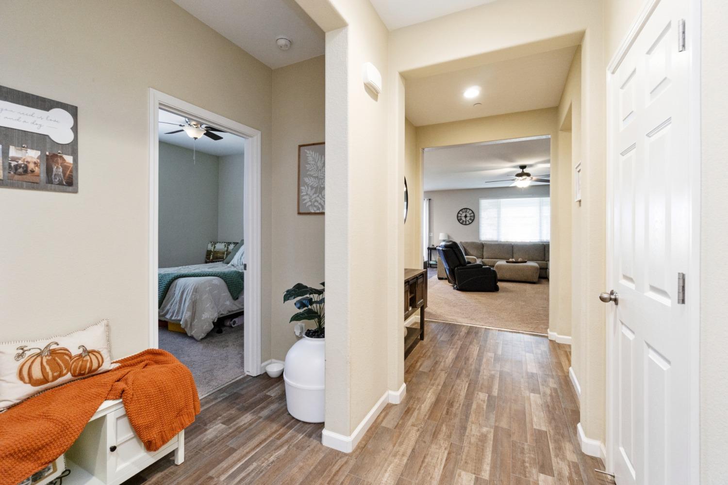 14340 West David Avenue Kerman, CA 93630 - Photo 9 of 30 a bedroom with furniture and a wooden floor