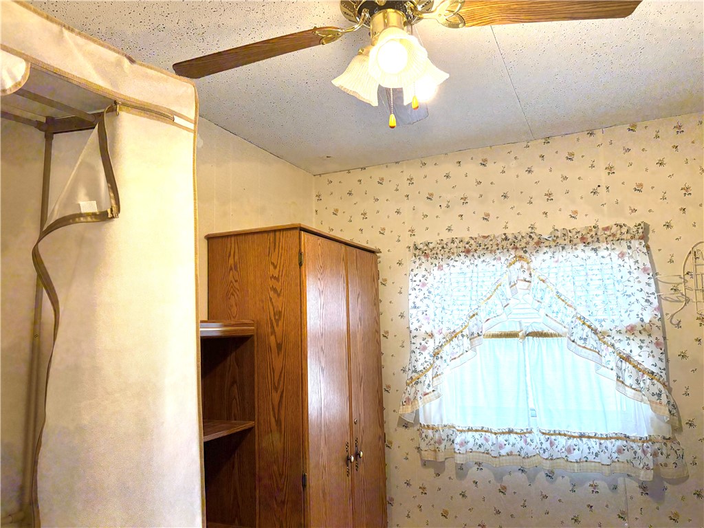 5434 North Waynesville Road, Unit 15 Oregonia, OH 45054 - Photo 8 of 19 This cozy bedroom features a window for natural light and a practical ceiling fan.