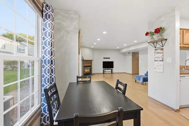 a dining room with furniture and a floor to ceiling window