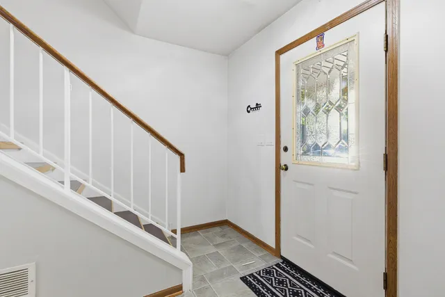 a view of entryway with wooden floor and stairs