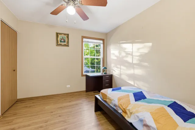 a living room with a bed furniture and a window