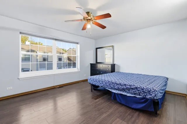 a room with a bed and a dresser