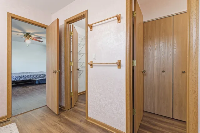 a view of a livingroom with wooden floor and a window