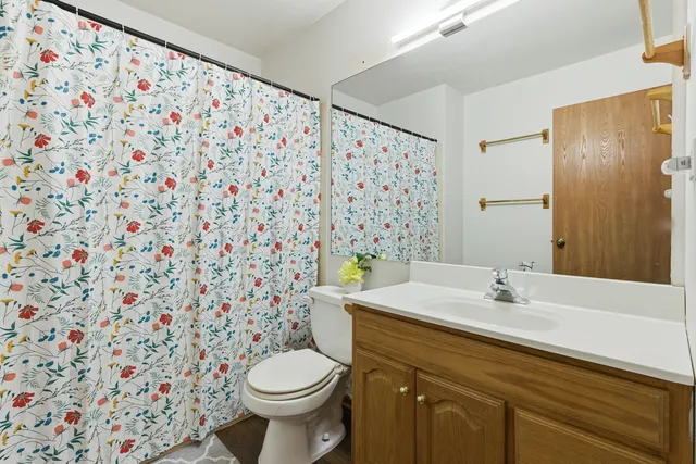 a view of a hallway with wooden floor and bedroom