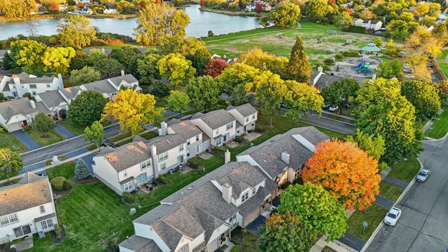 an aerial view of multiple houses with yard
