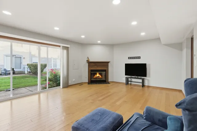 a view of livingroom with furniture a flat screen tv and wooden floor