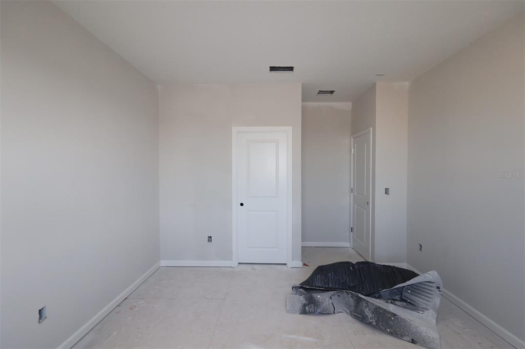 5291 High Line Drive St. Cloud, FL 34771 - Photo 18 of 24 a living room with a closet and a fireplace