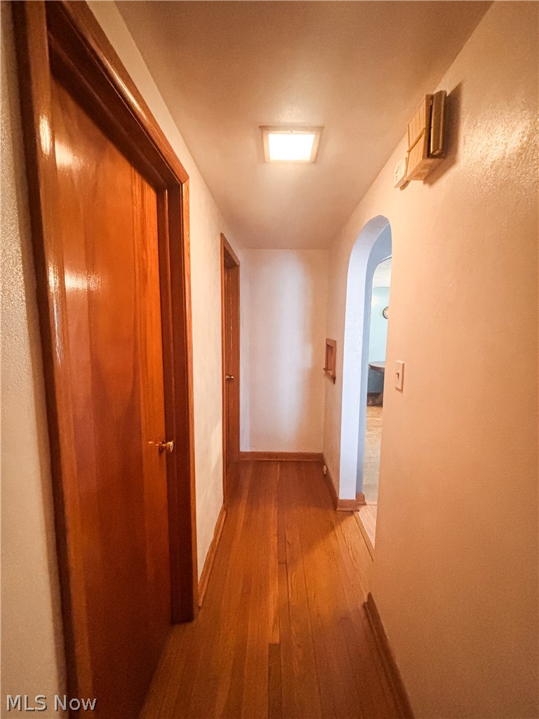 724 East Main Street Barnesville, OH 43713 - Photo 18 of 28 Hall featuring arched walkways and light wood-style flooring