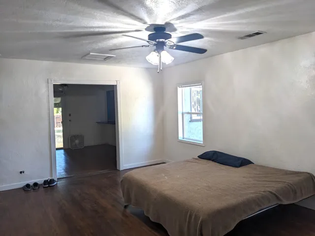 a bedroom with a bed and a chandelier