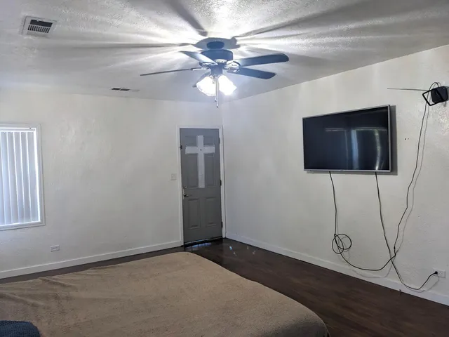 a view of a livingroom with furniture and chandelier fan