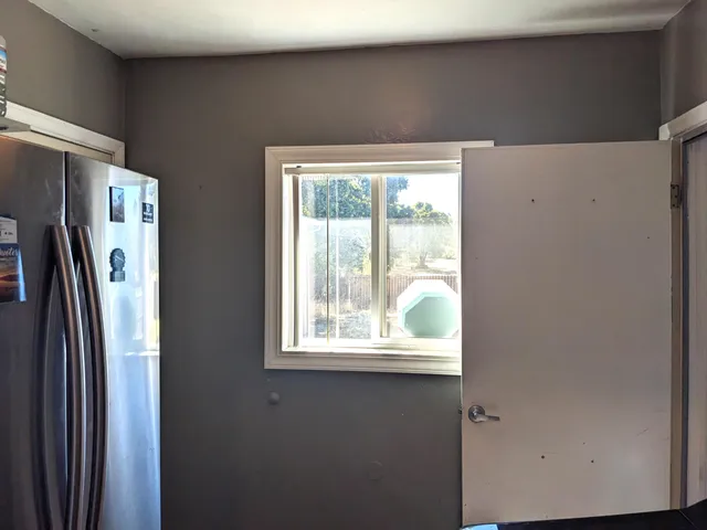 a kitchen with sink cabinets and window