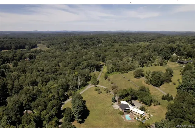 an aerial view of a houses with a yard