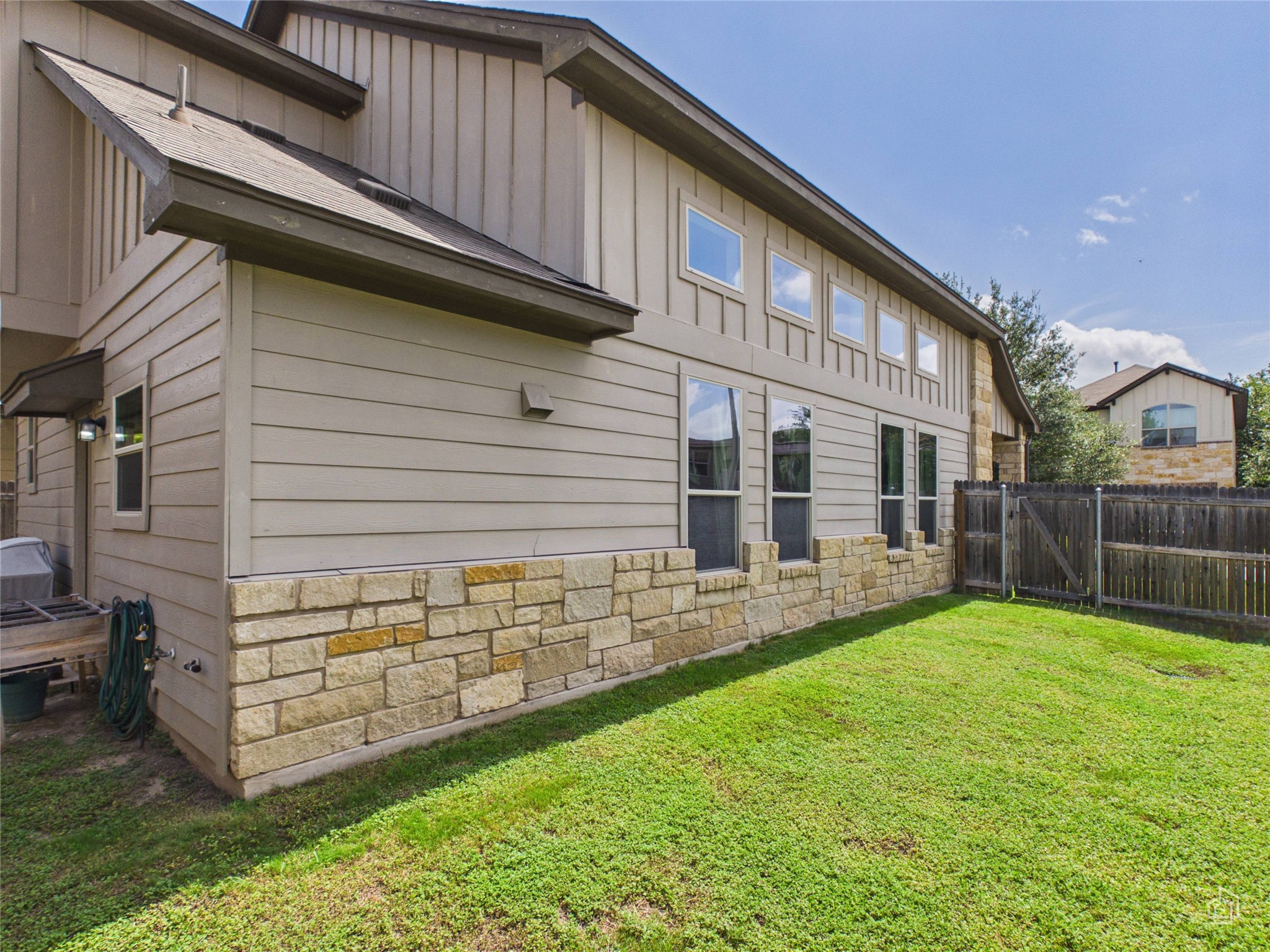 9310 Tanager Way Austin, TX 78748 - Photo 27 of 32 A well-maintained side yard with a sturdy wood fence, providing privacy and outdoor living space.