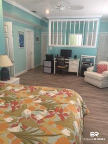 26595 Marina Road Orange Beach, AL 36561 - Photo 14 of 29 Look how large this master bedroom is. dressing area behind the screen opening into the master bath