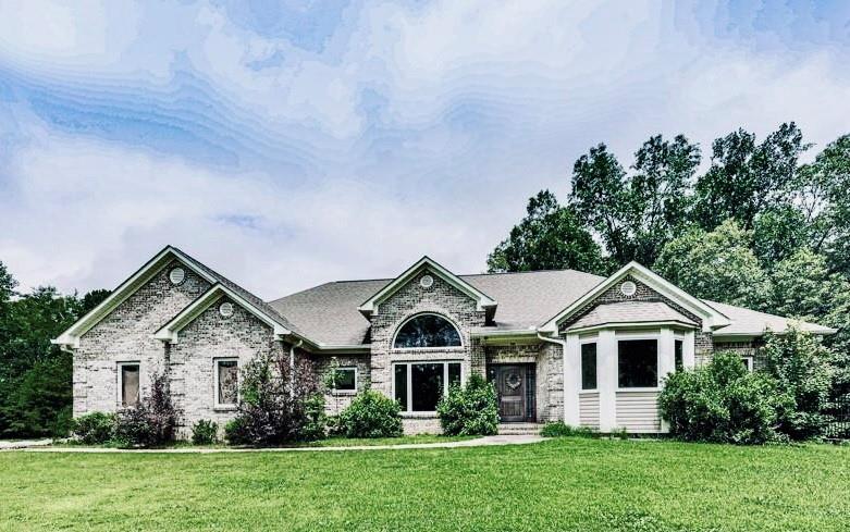 1650 Damascus Road Ball Ground, GA 30107 - Photo 1 of 1 a front view of a house with a yard and green space