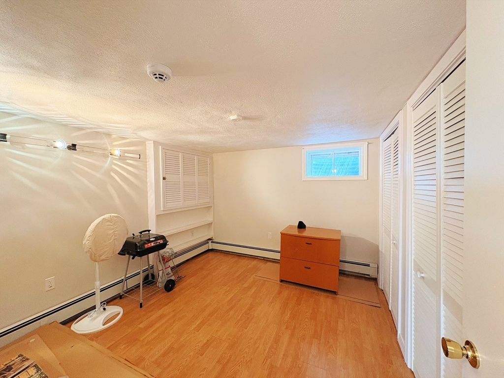 55 Sutherland Road, Unit 55 Arlington, MA 02476 - Photo 18 of 23 a room with gym equipment and wooden floor