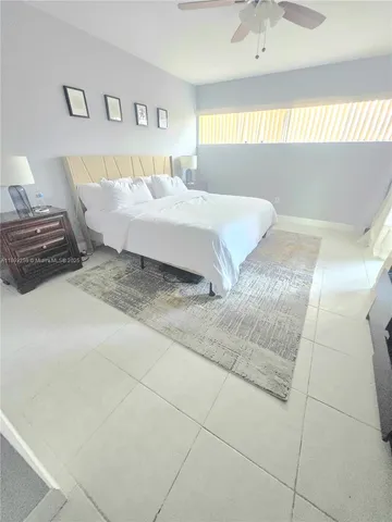 a spacious bedroom with a bed and window