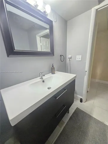 a spacious bathroom with a sink and a mirror
