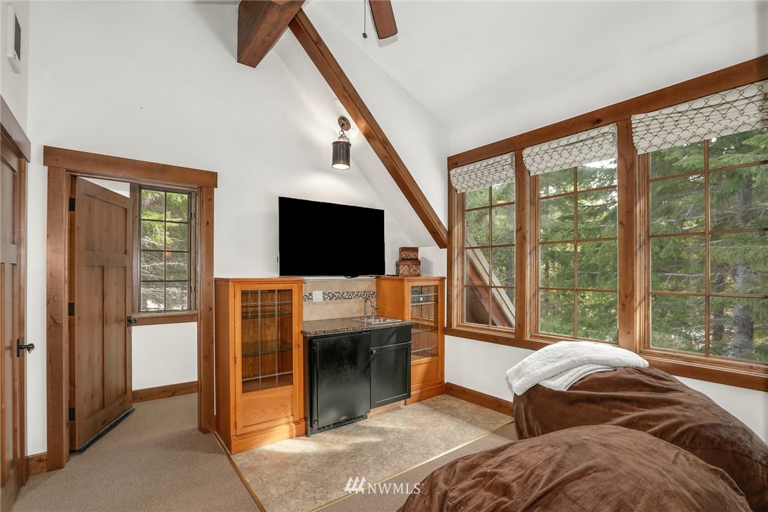 51 Rushing Water Lane Cle Elum, WA 98922 - Photo 22 of 28 a living room with a flat screen tv and a floor to ceiling window