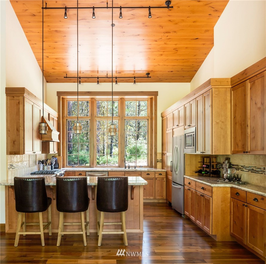 51 Rushing Water Lane Cle Elum, WA 98922 - Photo 9 of 28 a kitchen with a sink and chairs