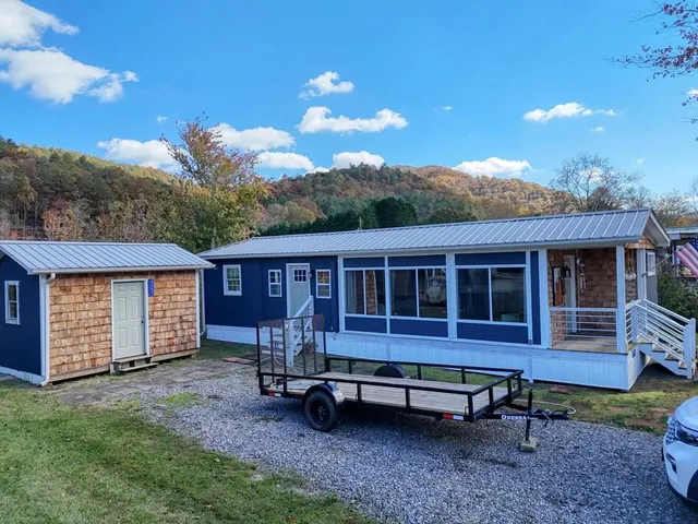 a backyard of a house with a yard and outdoor seating